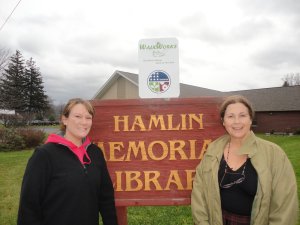 WalkWorks trail head sign at Hamlin Library in Smethport with Karen Howard and Jovanna Porter.